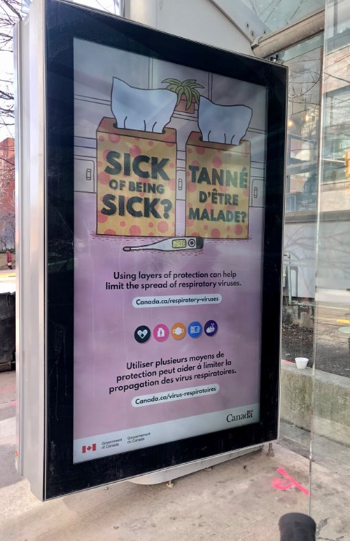 Figure 8: A bilingual Government of Canada advertisement regarding COVID-19 safety measures on a bus shelter in Toronto, March 2023 (photo by Ombudsman staff).