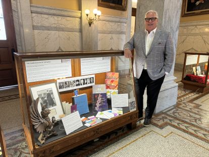 Ombudsman by the Office's display case at Queen's Park