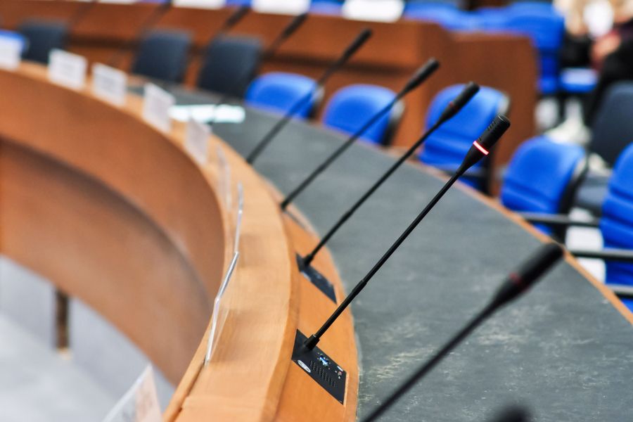 Meeting room with tables and individual microphones
