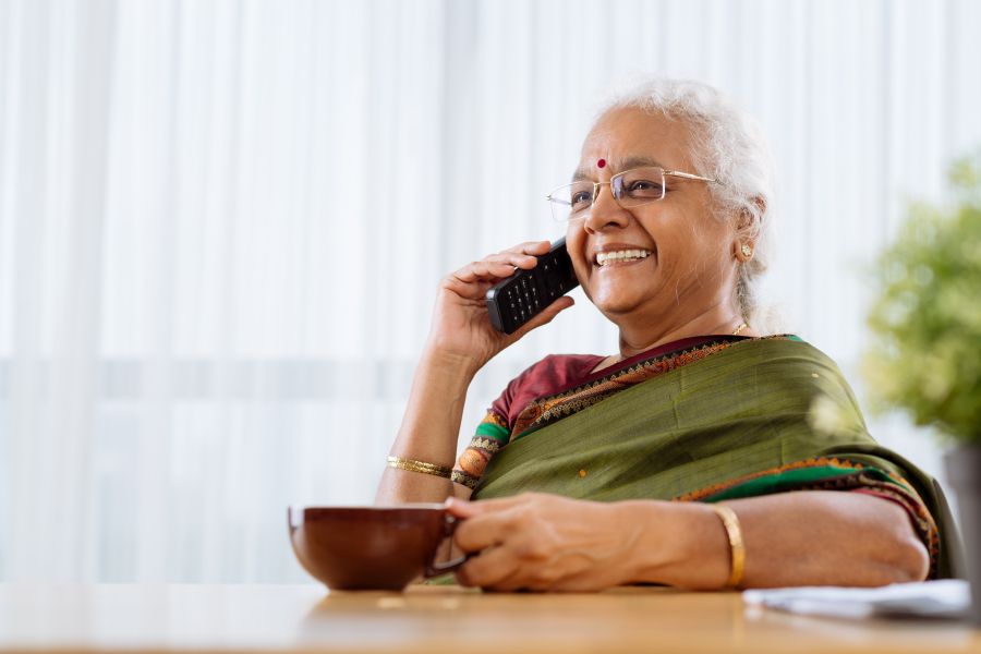 Woman smiling while talking on phone Woman smiling while talking on phone